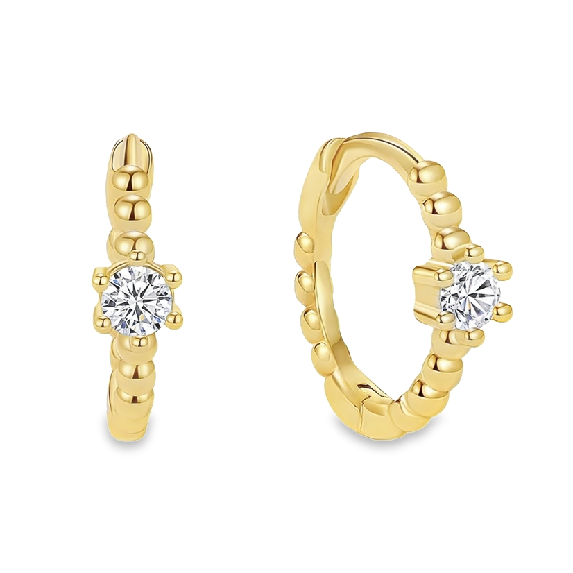 A pair of gold huggie hoop earrings with a round clear stone detailing.