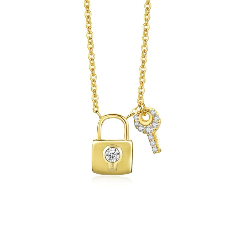 Gold necklace with lock and key pendants on a white background