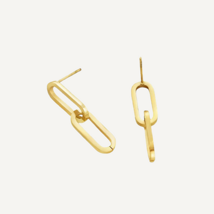 Gold hoop earrings on a light gray background