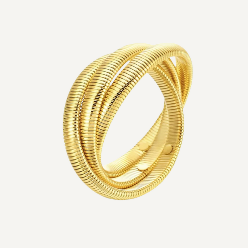 Gold bracelet on a light gray background