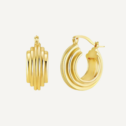 Gold hoop earrings on a light gray background