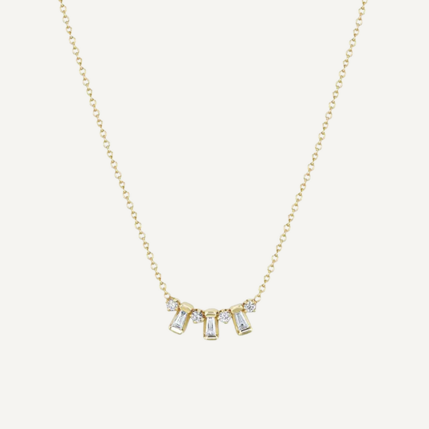Gold necklace with small diamonds on a white background