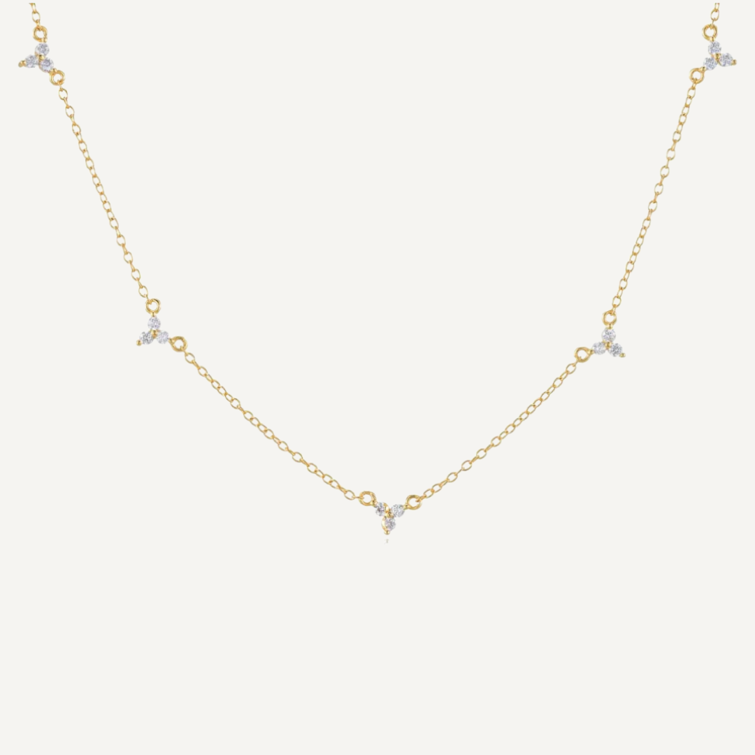 Gold necklace with small diamonds on a white background