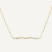 Gold necklace with small diamonds on a light gray background