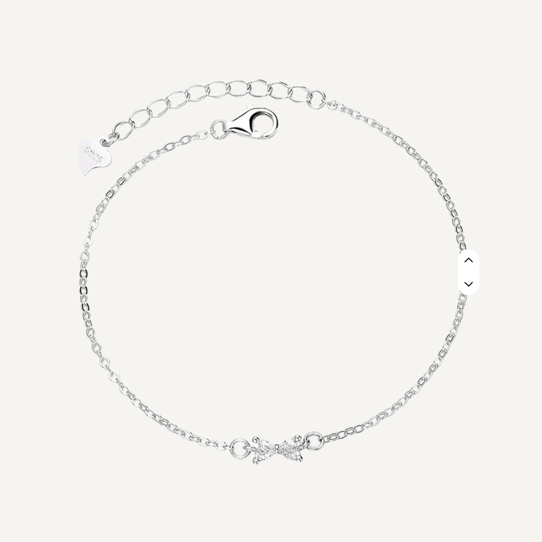 Teall Jewellery sterling silver bracelet featuring a delicate bow design at the centre with an adjustable chain and clasp, displayed on a white background