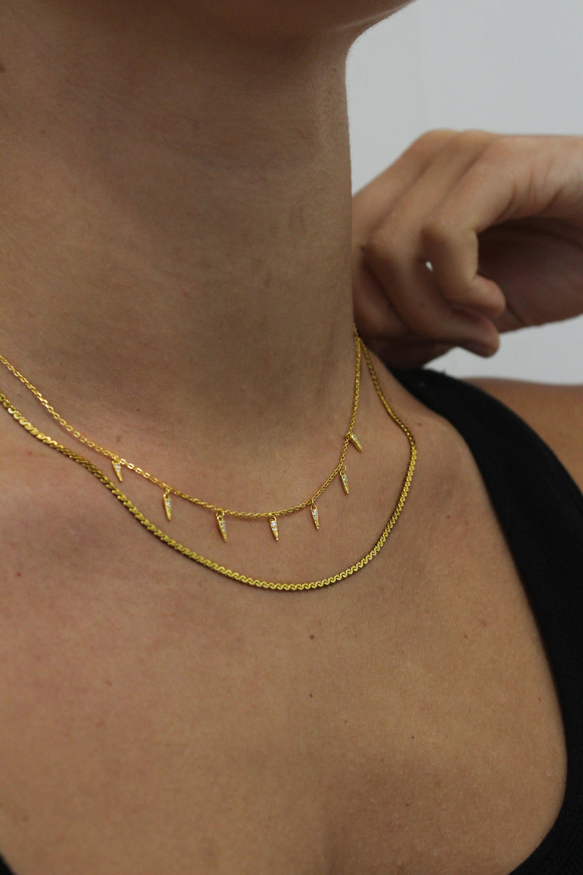 Teall Jewellery gold necklace featuring small clear stone triangle pendants evenly spaced along a fine chain, minimalist and elegant design on a white background