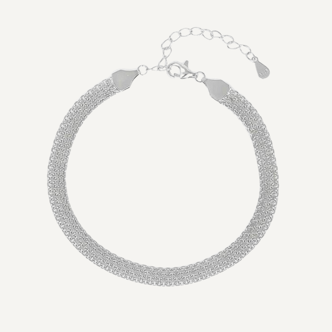 Silver bracelet on a light gray background