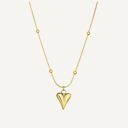 Gold heart-shaped pendant necklace on a white background