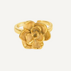 Gold flower-shaped ring on a light gray background