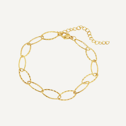 Gold chain bracelet on a light beige background