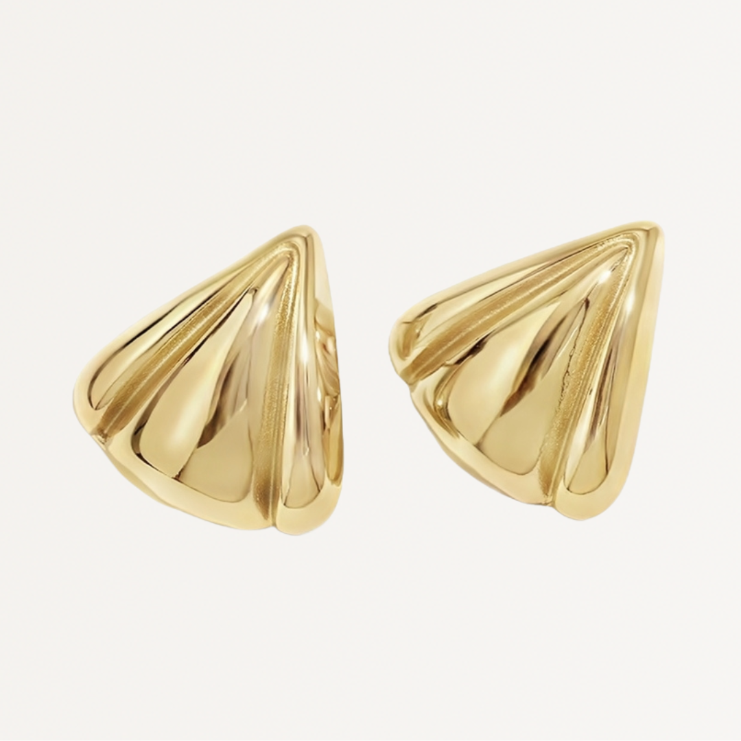 Gold cone-shaped earrings on a light beige background