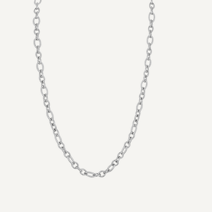 Silver chain necklace on a light gray background