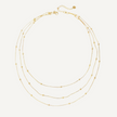 Gold necklace with multiple strands on a white background
