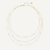 Gold necklace with multiple strands on a white background
