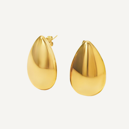 Gold teardrop earrings on a light gray background