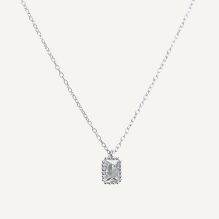 Silver necklace with a rectangular pendant on a light gray background