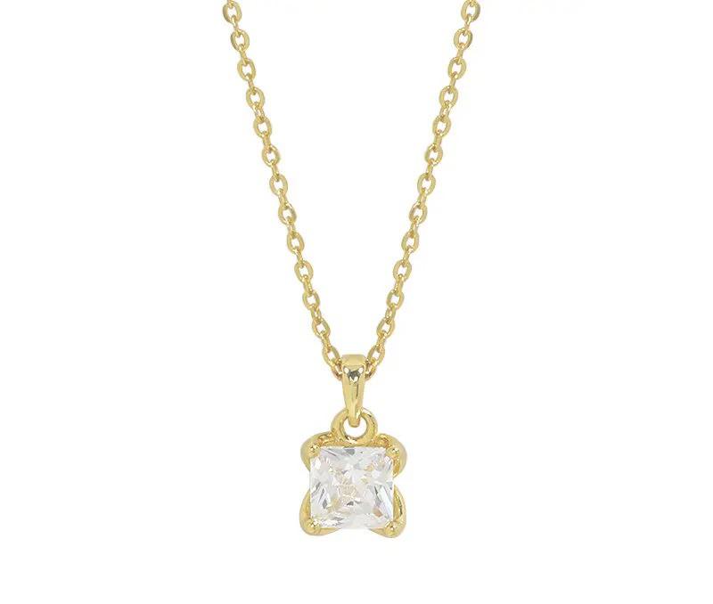 A gold chain necklace with a square clear gemstone detailing on a pendant.