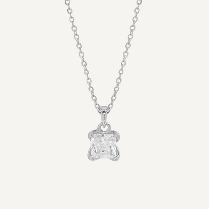 Silver necklace with a star-shaped pendant on a light gray background