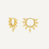 Gold hoop earrings with spike details on a light beige background