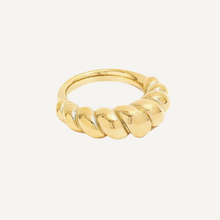 Gold ring with a textured design on a white background