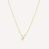 Gold necklace with a small pendant on a light gray background
