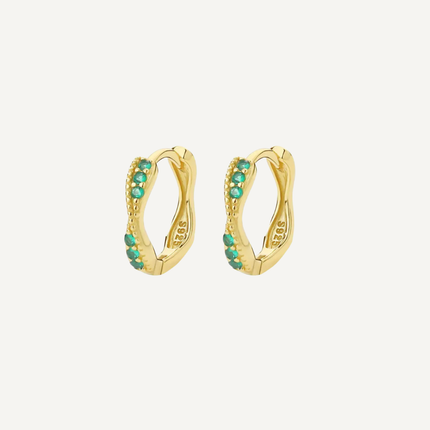 Gold hoop earrings with green gemstones on a white background