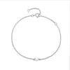 A sterling silver bracelet featuring a single freshwater pearl, with a chain of pearls adding a subtle elegance.