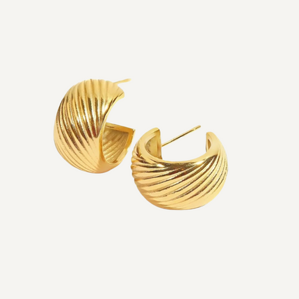 Gold hoop earrings on a white background