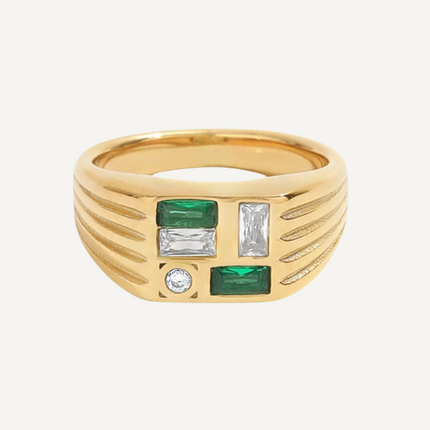 Gold ring with emerald and diamond accents on a white background