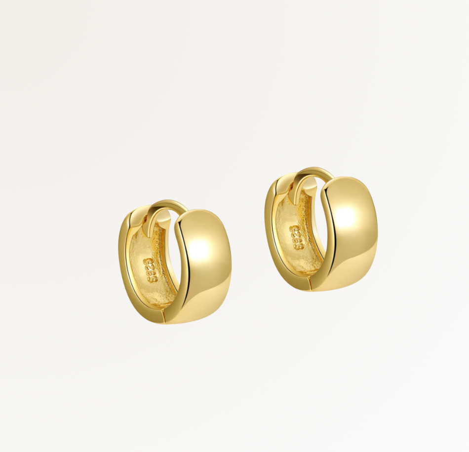 Gold hoop earrings on a light gray background, Siena Huggies by Teall Jewellery Perth Australia 