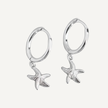 Silver hoop earrings with starfish charms on a light gray background