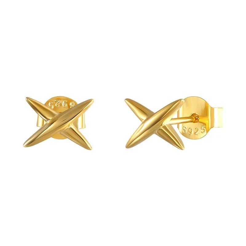 A pair of gold-colored sterling silver star-shaped stud earrings with the brand name 'TEALL' visible on the earrings.Teall Gold Cross Stud Earrings l Hypoallergenic