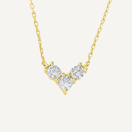 Gold necklace with three diamond-like stones on a white background