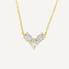 Gold necklace with three diamond-like stones on a white background