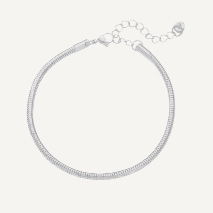 Silver snake chain bracelet on a light gray background
